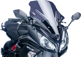 PUIG Racing Dark Smoke Windscreen for motorcycle, with tinted dark smoke finish and aerodynamic design, mounted on bike.