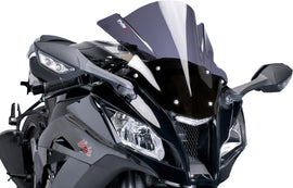 Black PUIG Racing Windscreen for motorcycle, aerodynamic design, mounted on bike with clear visibility and sleek racing style.