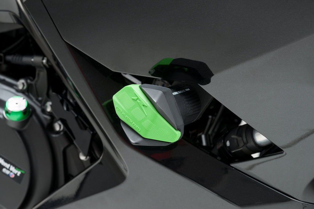 PUIG green frame slider R12 end body protector mounted on motorcycle frame, showing durable construction and vibrant green color.