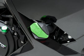 PUIG green frame slider R12 end body protector mounted on motorcycle frame, showing durable construction and vibrant green color.