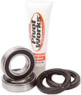 Pivot Works front wheel bearing kit 52-0438 for drive wheel, showing bearings and components on a clean work surface