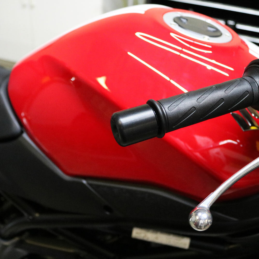 Black Shogun Industries Bar End Sliders installed on motorcycle handlebars, showcasing durable body protection.