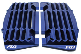 Flo Motorsports high flow radiator braces in blue, showcasing sturdy metal construction designed for optimal engine cooling.