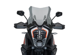 PUIG touring smoke windscreen for KTM motorcycle, shown mounted on bike, providing wind protection and a sleek appearance.