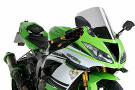 Clear PUIG Windscreen R-Racer for Kawasaki motorcycle, showing the transparent windshield with mounting edges.
