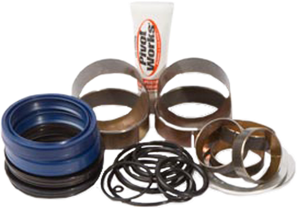 Pivot Works suspension seal and bushing kit for forks, showing various seals and bushings laid out on a clean surface.