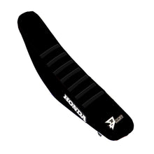 Load image into Gallery viewer, DCOR black ribbed seat cover for CRF250/450 motorcycle, showing textured black material and secure fit details.