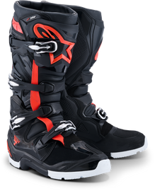 Alpine Star Tech 7 Enduro motorcycle boots in black, red fluo, and white, showing the sturdy design and branding details.