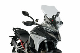 Clear PUIG touring motorcycle windshield, designed for Ducati models, provides wind protection and improved aerodynamics.