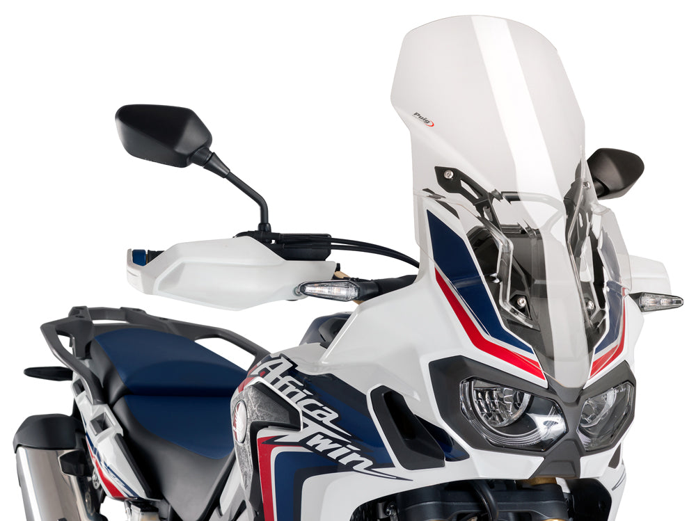 Clear PUIG Touring Windscreen mounted on motorcycle, providing wind protection with a sleek, aerodynamic design.