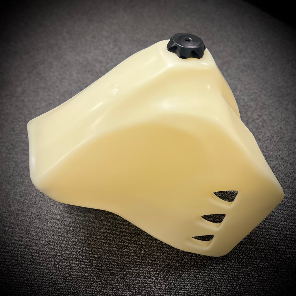 IMS Fuel Tank Natural 6.6 Gal for Kawasaki, showing the black fuel tank with mounting components and brand label.