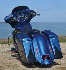 Accutronix Tribal Bag Lights chrome with red lens for motorcycle illumination, featuring a tribal design and sleek chrome finish.