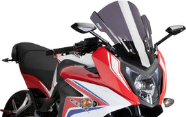 PUIG touring dark smoke windshield for motorcycle, featuring a sleek, tinted windscreen with mounting brackets.