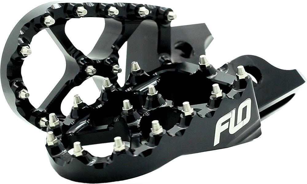 Black Flo Motorsports Pro Series foot pegs with textured surface for motorcycle or ATV, shown installed on the vehicle.