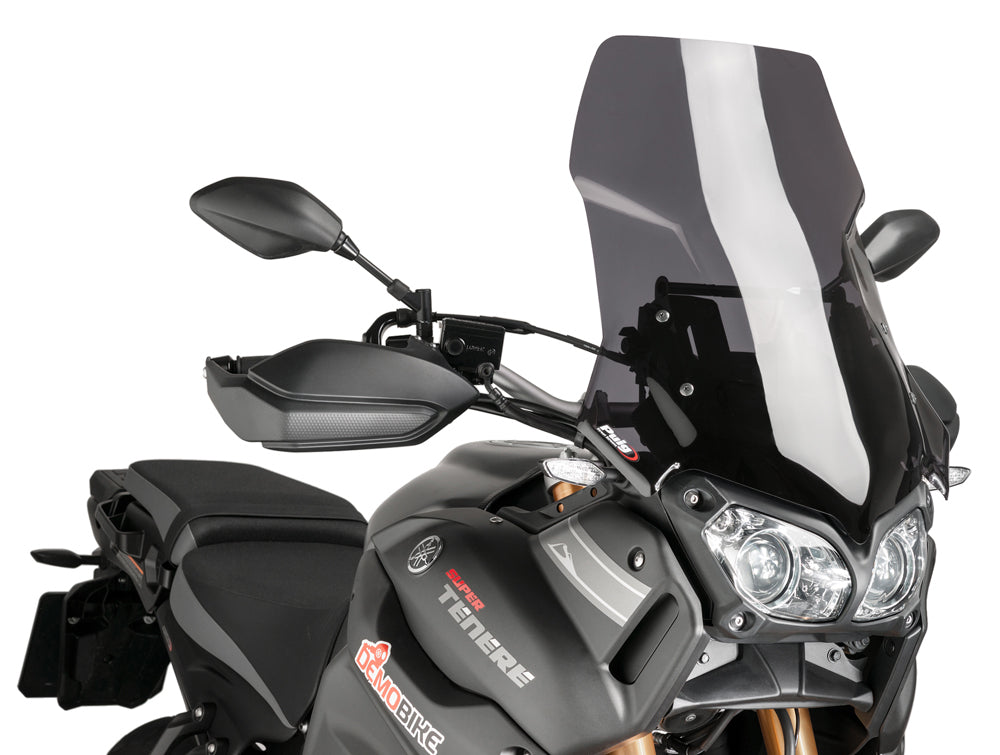 PUIG touring dark smoke windshield for motorcycle, showing the tinted, aerodynamic design and mounting edges.
