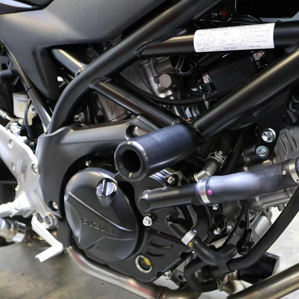 Shogun Industries black Suz 71-14014 frame sliders mounted on a motorcycle body for protection.