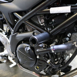 Shogun Industries black Suz 71-14014 frame sliders mounted on a motorcycle body for protection.