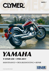 Clymer repair manual for Yamaha XVS650 V-Star motorcycle, showing detailed pages and diagrams for maintenance and repairs.