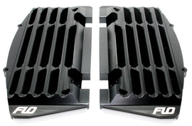 Black Flo Motorsports High Flow Radiator Braces installed on a vehicle, showcasing sturdy metal construction and precise fit.