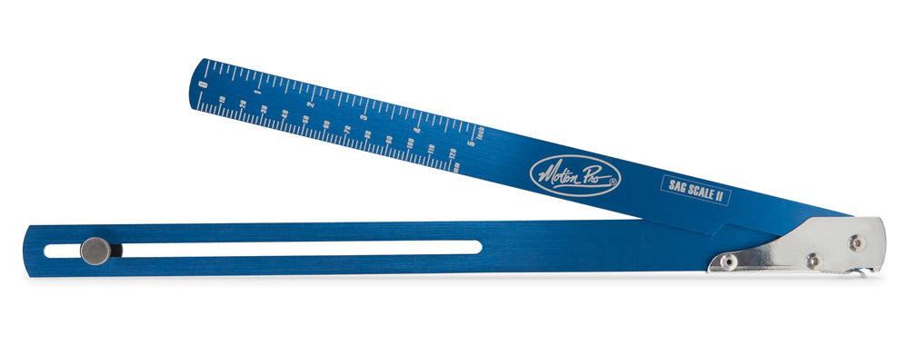 Motion Pro Sag Scale II tool used for motorcycle suspension adjustment, featuring a clear measurement scale and durable construction.