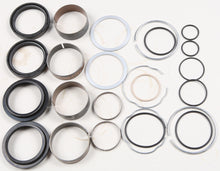 Load image into Gallery viewer, Pivot Works suspension seal and bushing kit for forks, featuring various seals and bushings arranged for installation.