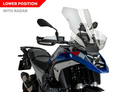 Clear PUIG touring windshield for BMW motorcycle, showing the transparent, curved windscreen mounted on the bike.