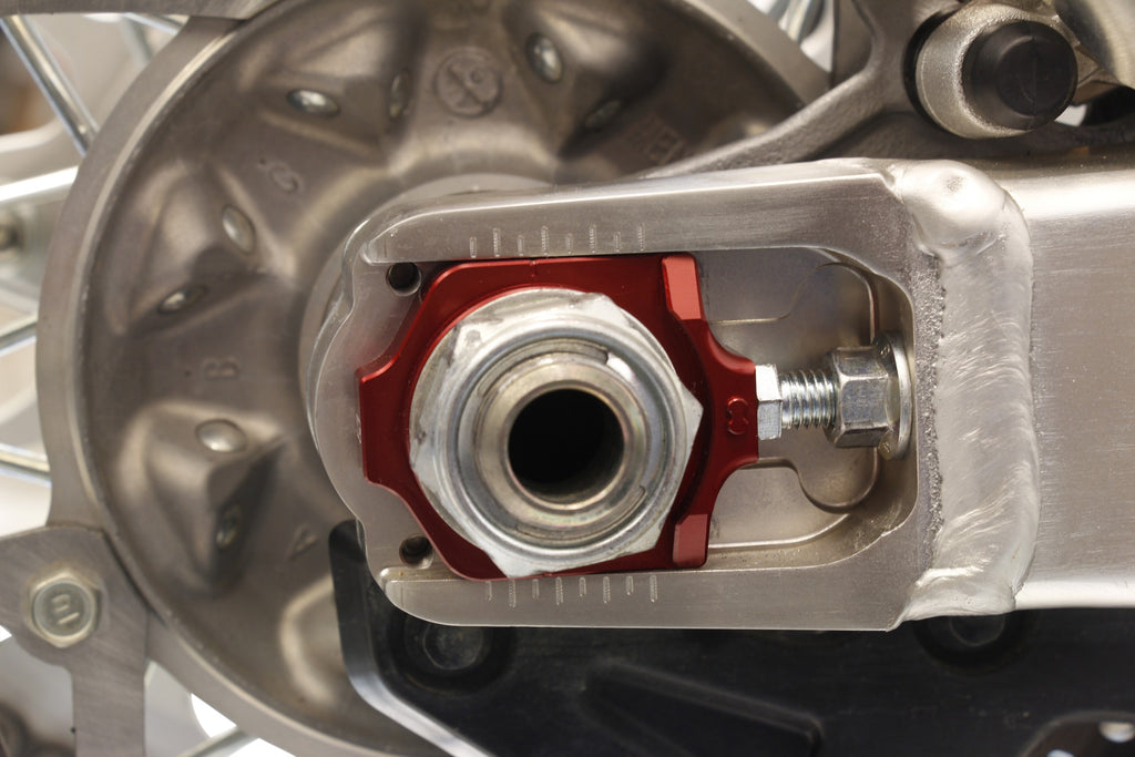 WORKS Axle Blocks Elite Hon Red drive axle blocks with a sleek red finish, designed for secure vehicle support during maintenance.