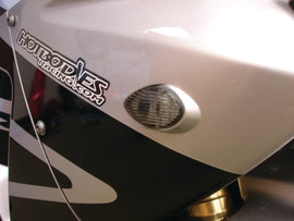 Hotbodies Racing flush mount signal in smoke, showcasing the sleek, smoked lens and compact design for motorcycle or vehicle lighting.