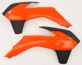 Acerbis radiator shroud in orange and black with a sleek design, fitting motorcycle cooling systems.
