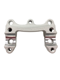 Silver HeliBars handlebar riser with triangular design, designed for enhanced comfort and control on motorcycle handlebars.