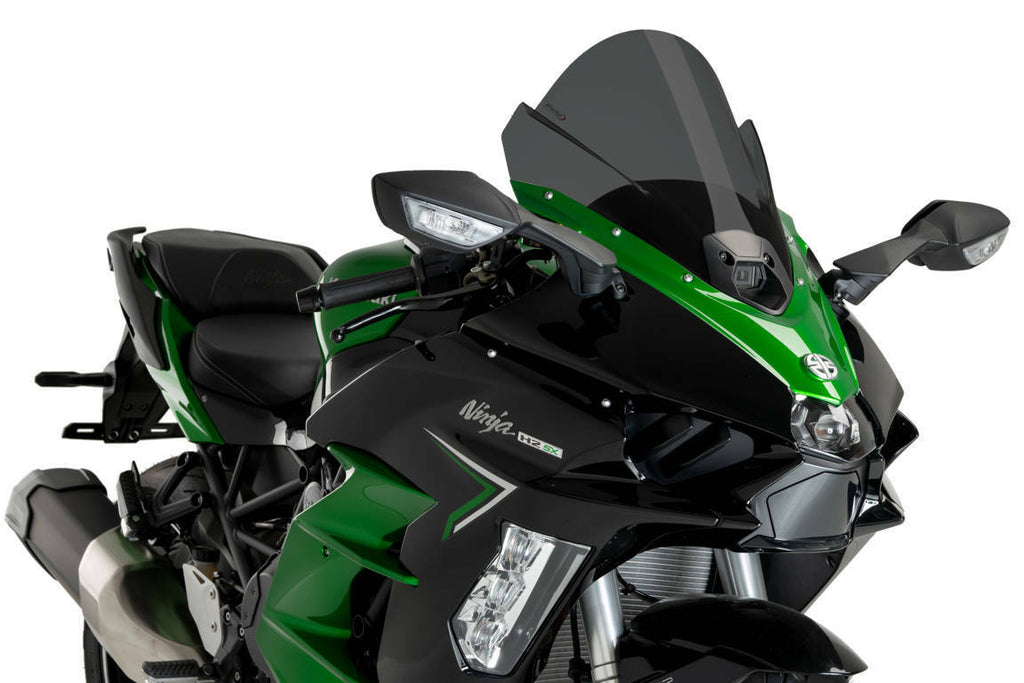 PUIG Z-Racing dark smoke motorcycle windshield for Kawasaki, aerodynamic windscreen with sleek tinted finish, mounted on bike.