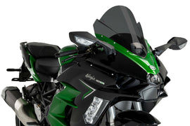 PUIG Z-Racing dark smoke motorcycle windshield for Kawasaki, aerodynamic windscreen with sleek tinted finish, mounted on bike.