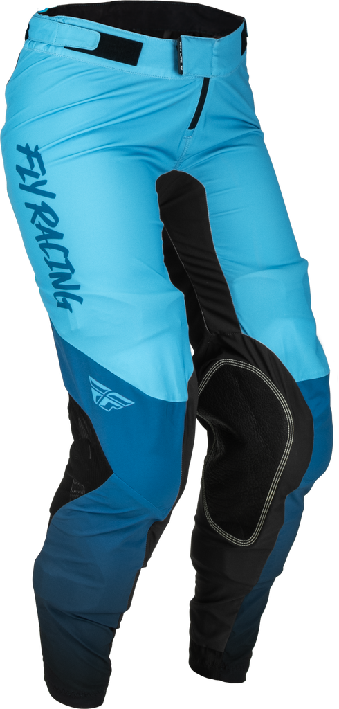 Fly Racing Women's Lite Pants in blue and black, size 05/06, shown on a model with close-up of the fabric and design details.