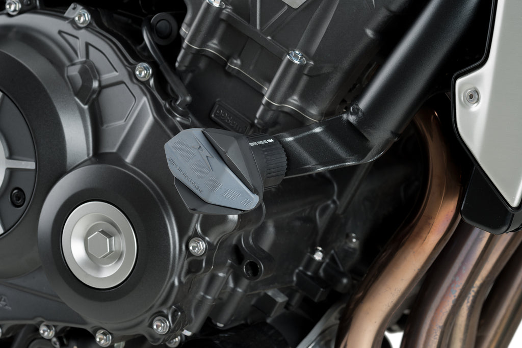 PUIG R19 black frame sliders mounted on a motorcycle body, providing protection and a sleek, aerodynamic look.
