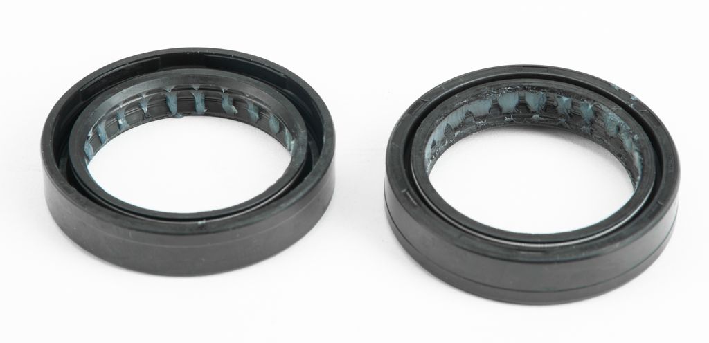 ProX Racing Parts suspension fork seals, model 68-2422, showing close-up of black rubber seals on a motorcycle suspension fork