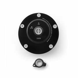 RIZOMA black gas cap lock with locking mechanism and textured surface for motorcycle fuel tank security.