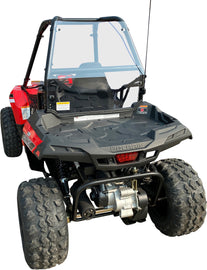Open Trail rear windscreen in clear polycarbonate for Polaris Ace 150, showing the transparent, durable ATV windshield in natural setting.