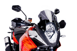 PUIG Racing Dark Smoke Windscreen for motorcycle, featuring a sleek dark tinted shield with mounting hardware visible.
