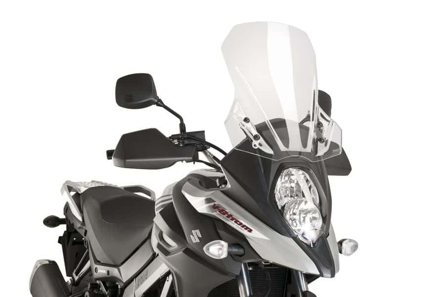 Clear PUIG touring windshield for Suzuki motorcycle, showing the transparent, curved windscreen mounted on the bike.