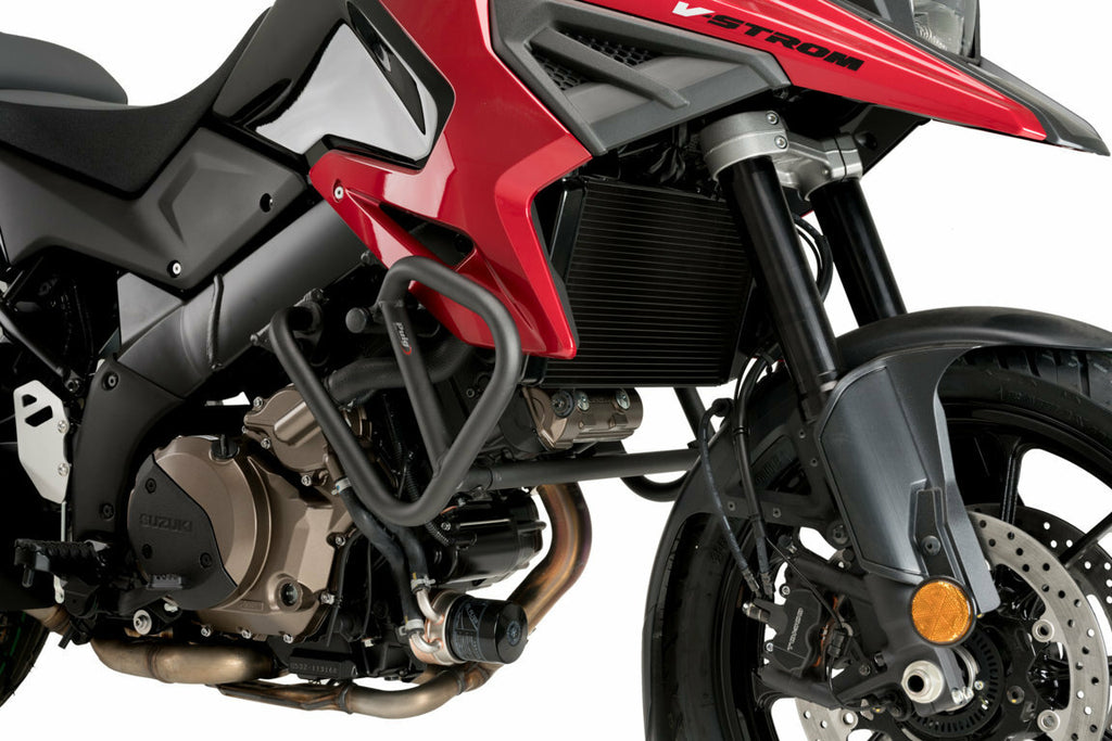 Black PUIG engine guards for Suzuki motorcycle, shown mounted on engine area with protective braces and mounting hardware.