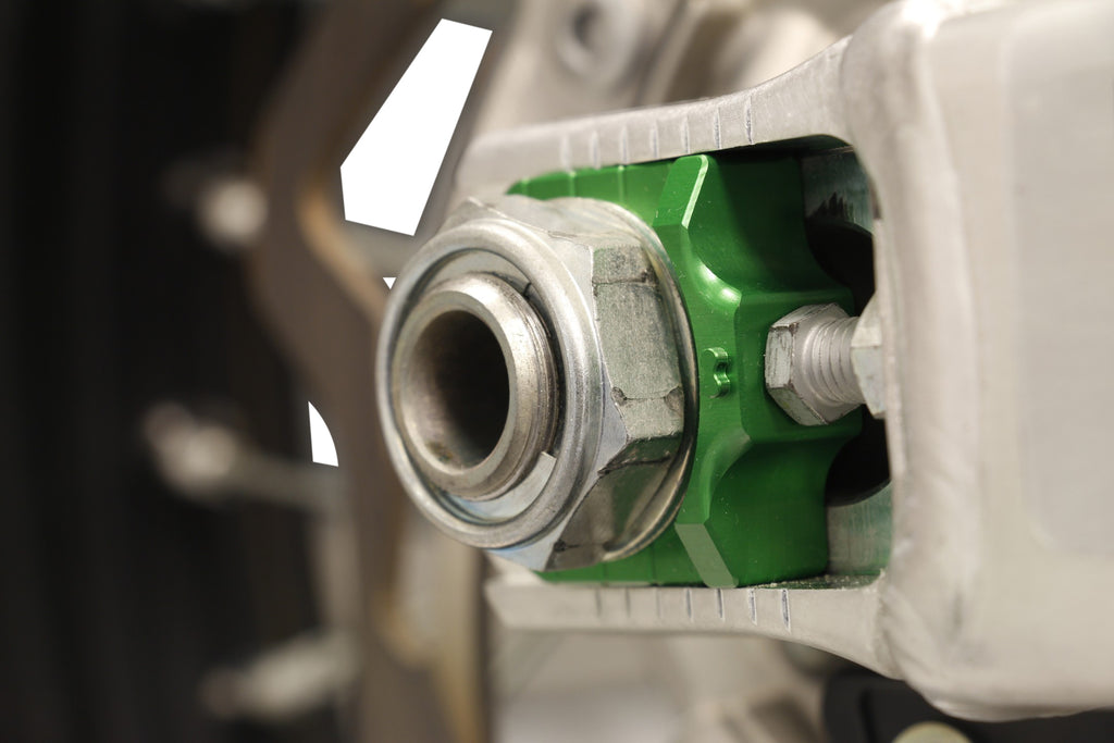 WORKS Axle Blocks Elite Kawasaki and Suzuki green drive blocks for motorcycle wheel alignment, shown in the image.