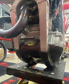 P3 Carbon Fiber Skid Plate for Honda CRF250 motorcycle, showing sleek black protective guard on bike's underside