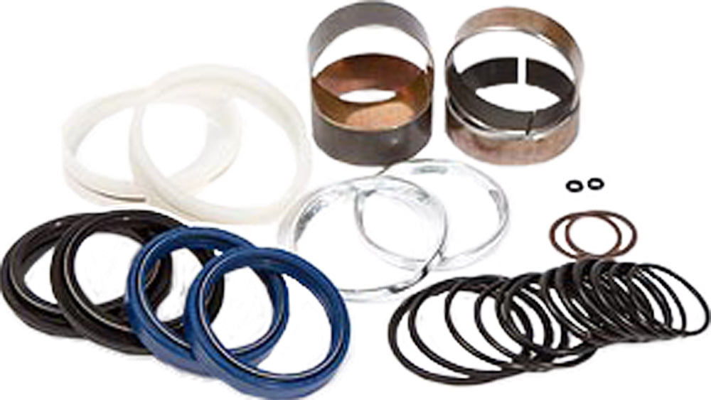 Pivot Works suspension seal and bushing kit for forks, showing various seals and bushings arranged on a white background.