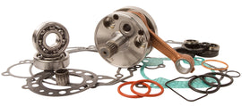 Hot Rods Bottom End Kit for engine with metal components and pistons, showing parts arranged on a work surface.