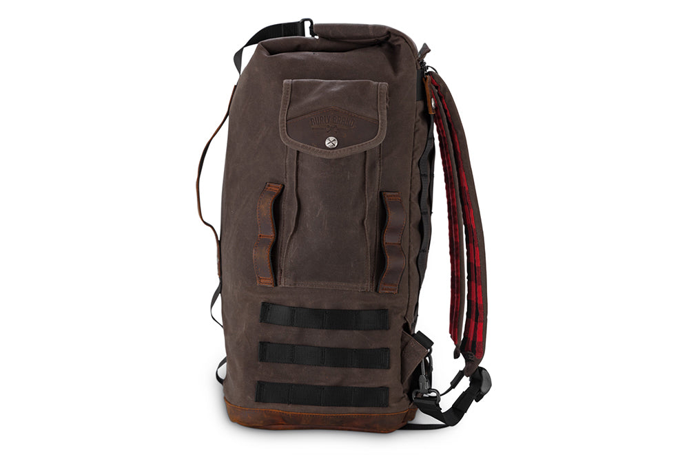 Dark oak Burly Brand sissy bar bag on motorcycle luggage rack, showing durable material and secure straps for motorcycle storage.