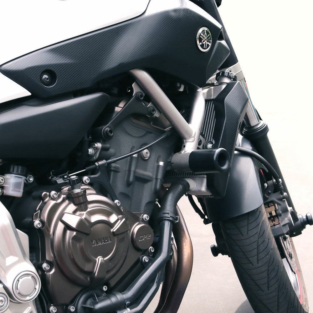 Shogun Industries black frame sliders for Yamaha YZ, mounted on motorcycle body for protection and style.
