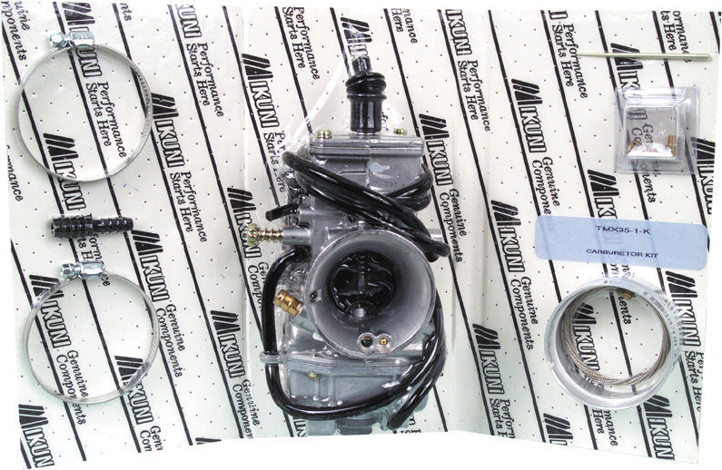 Mikuni TMX 38mm flat slide carburetor kit for motorcycle fuel system, shown with metal components and throttle slide.