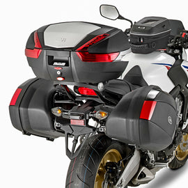GIVI top case hardware mount bracket for motorcycle luggage, shown in black with mounting components on a neutral background.