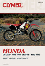 Load image into Gallery viewer, Clymer repair manual for Honda CR125 and CR250R motorcycles, open pages showing detailed maintenance instructions and diagrams.