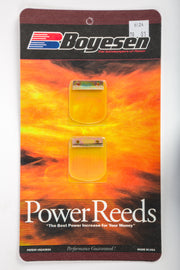 Boyesen motorcycle intake/reed system with black reed valves and metal mounting plates for enhanced engine performance.